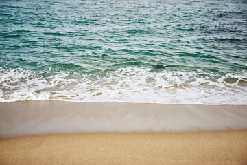 Fototapeta na wymiar White waves on a sandy beach, East Sea, South Korea