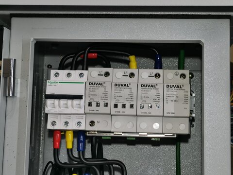 Photo of Surge Protection Devices with miniature circuit breaker in electrical cabinet.