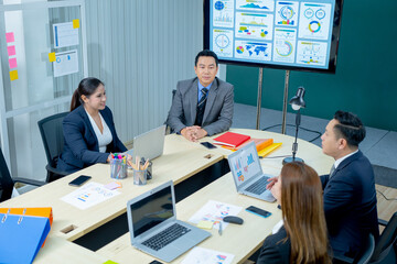 Office Conference Business Meeting Presentation: asian Business people group meeting Talks, Uses Wall TV to Show Company Growth with Big Data Analysis, Graphs, Charts, Infographics, e-Commerce Startup
