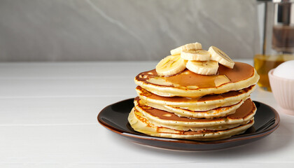 Tasty pancakes with sliced banana served on white table, space for text