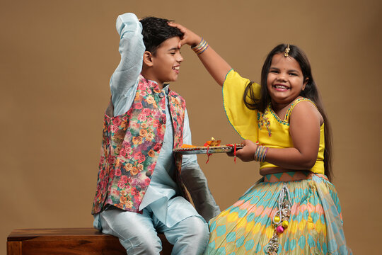 Indian asian cute little kids celebrating Raksha Bandhan,Bhai Dooj