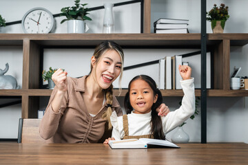 Mother teaching daughter homework lesson at home preschool student. Teaching children learning in the house education.