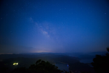 Galactic Serenity: Nighttime Skyline at the Mountain Summit. Starry sky in summer at Crocodile Island in Shiding District, New Taipei City.