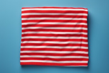 Fototapeta premium Red And White Striped Beach Towel On An Isolated Blue Background, Generative AI