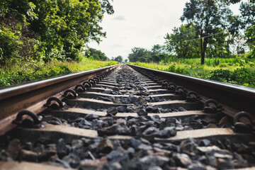 Fototapeta na wymiar Rural train tracks with beautiful nature on both sides of the road