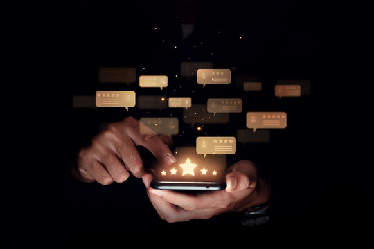 Consumer reviews concept, Hand of man using smartphone with five star for evaluate product and service.
