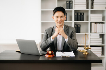 justice and law concept .Asian Male judge in a courtroom on table and Counselor working in office.