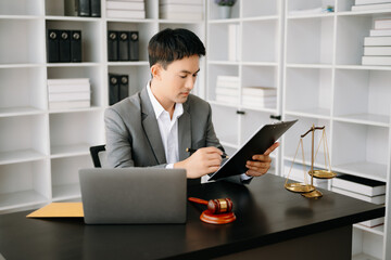 justice and law concept .Asian Male judge in a courtroom on table and Counselor working in office.
