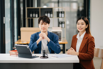 Business people compassionately holding hands and discussing contract papers with laptop and tabletat in office room.