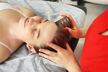 the masseur does a relaxing facial massage with the help of a horny Chinese fascial massager