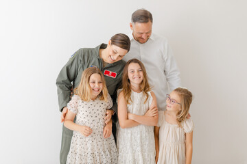 happy family with active duty military mom in uniform