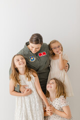 happy family with active duty military mom in uniform