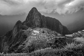 View of Macchu Picchu from the entrance, under a stormy sky