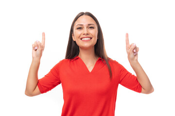 surprised brunette woman in a red stylish v-neck blouse shows her hand to the empty space