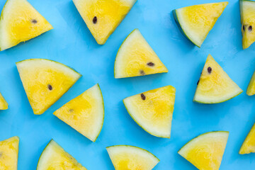 Yellow watermelon slices on blue background.