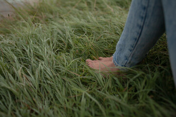 Close-up of the female legs in the grass