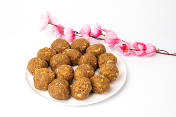 Indian home made sweets on white plate, white background