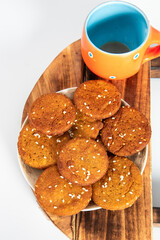 Indian Homemade Cookies with emply tea cup on plate, white background, bunch of cookies