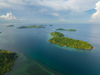 Fototapeta na wymiar Islands surrounded by azure water and corals. Zamboanga City. Mindanao, Philippines. Seascape. Travel concept.