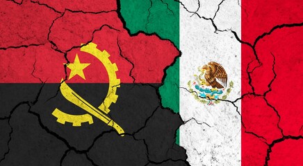 Flags of Angola and Mexico on cracked surface - politics, relationship concept