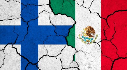 Flags of Finland and Mexico on cracked surface - politics, relationship concept