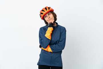Young English cyclist woman isolated on white background having doubts