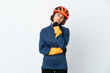 Young English cyclist woman isolated on white background and looking up