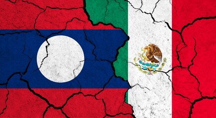 Flags of Laos and Mexico on cracked surface - politics, relationship concept
