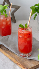 red watermelon cocktail with ice and mint
