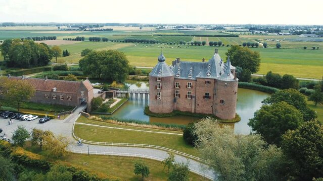 Ammersoyen castle: aerial view traveling in from the side of the beautiful castle and making out the bridge and the moat that surrounds it. In the Netherlands on a sunny day.