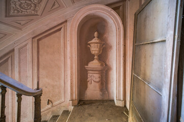 a frescoed cup on the stairs of an abandoned villa