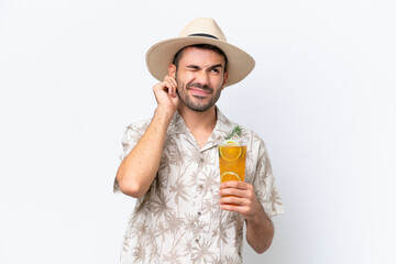 Young caucasian man holding a cocktail isolated on white background frustrated and covering ears