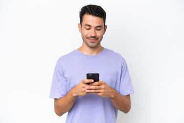 Young handsome man over isolated white background sending a message or email with the mobile