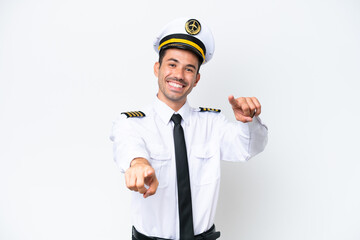 Airplane pilot over isolated white background points finger at you while smiling