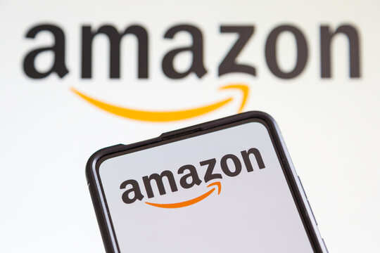 Amazon logo online marketplace ecommerce on a mobile phone and computer screen
