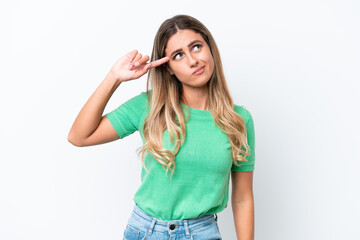 Young Uruguayan woman isolated on white background making the gesture of madness putting finger on...