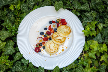 Delicious breakfast. cheesecakes with raspberries and blueberries. Close-up