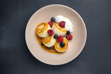 Delicious breakfast. cheesecakes with raspberries and blueberries. Close-up