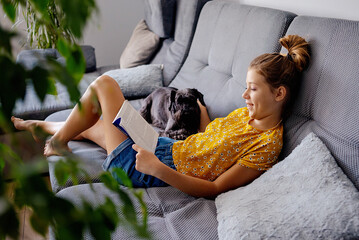 digital detox and leisure concept. girl reading book at home