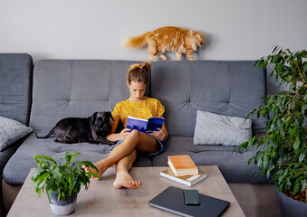 digital detox and leisure concept. girl reading book at home