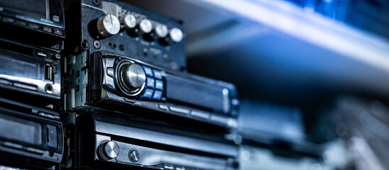 Car radio and audio CD player stacking on rack in auto part shop. Automobile industry