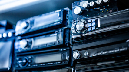 Car radio and audio CD player stacking on rack in auto part shop. Automobile industry