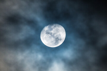 Naklejka na ściany i meble Waning gibbous moon at 92 percent illuminated with clouds drifting past in the dark night sky