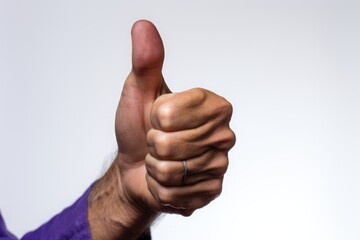 This is a photo of a person giving a thumbs up sign.