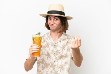 Young handsome man holding a cocktail isolated on white background making money gesture