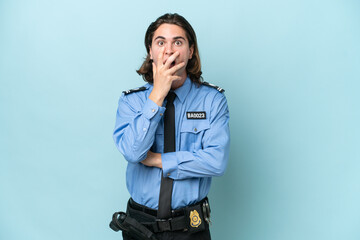 Young police caucasian man isolated on blue background surprised and shocked while looking right