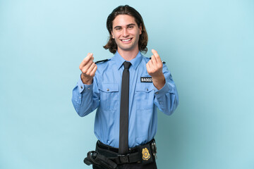 Young police caucasian man isolated on blue background making money gesture