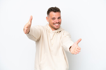 Young caucasian handsome man isolated on white background presenting and inviting to come with hand