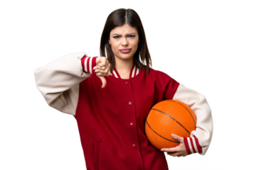 Young Russian woman playing basketball over isolated chroma key background showing thumb down with negative expression