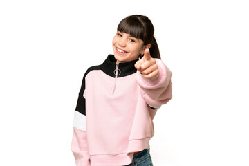 Little girl over isolated green chroma key background pointing front with happy expression